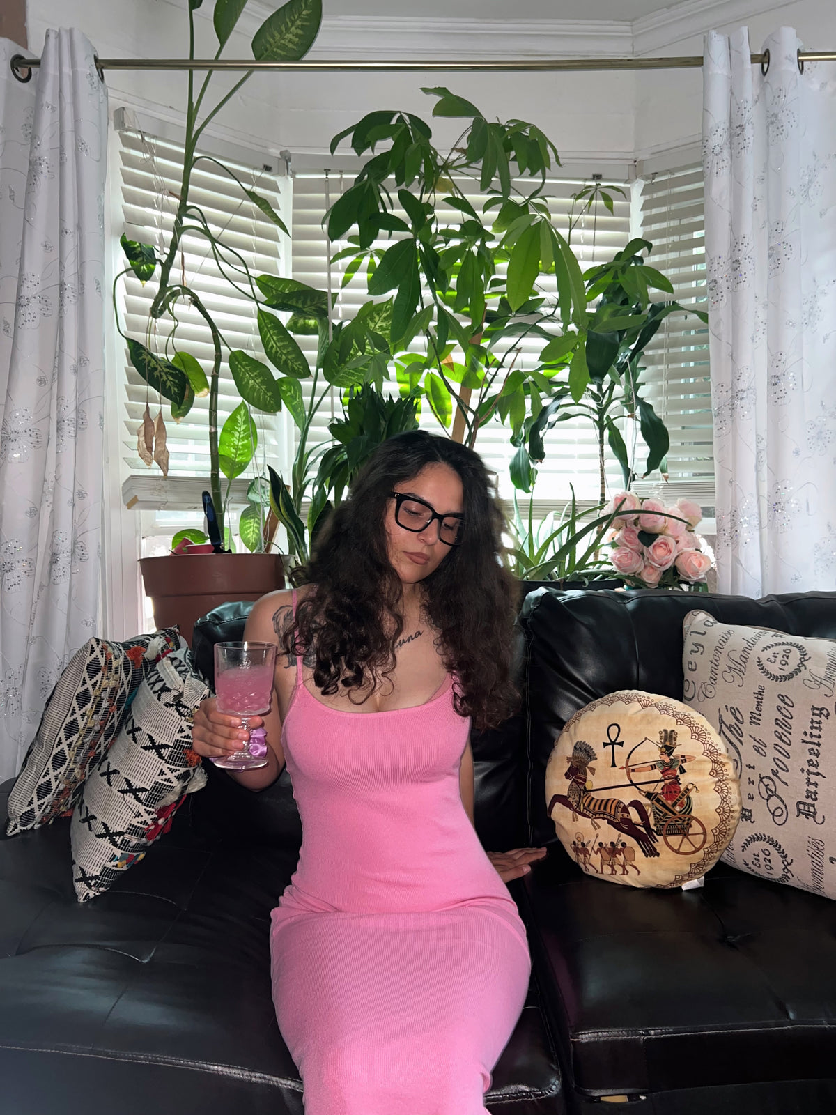 Founder of Root Cause Remedy relaxing at home surrounded by plants