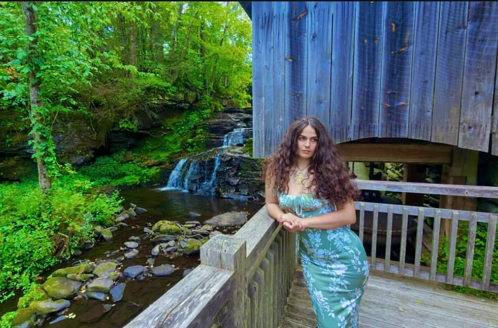 Founder of Root Cause Remedy outdoors near a waterfall